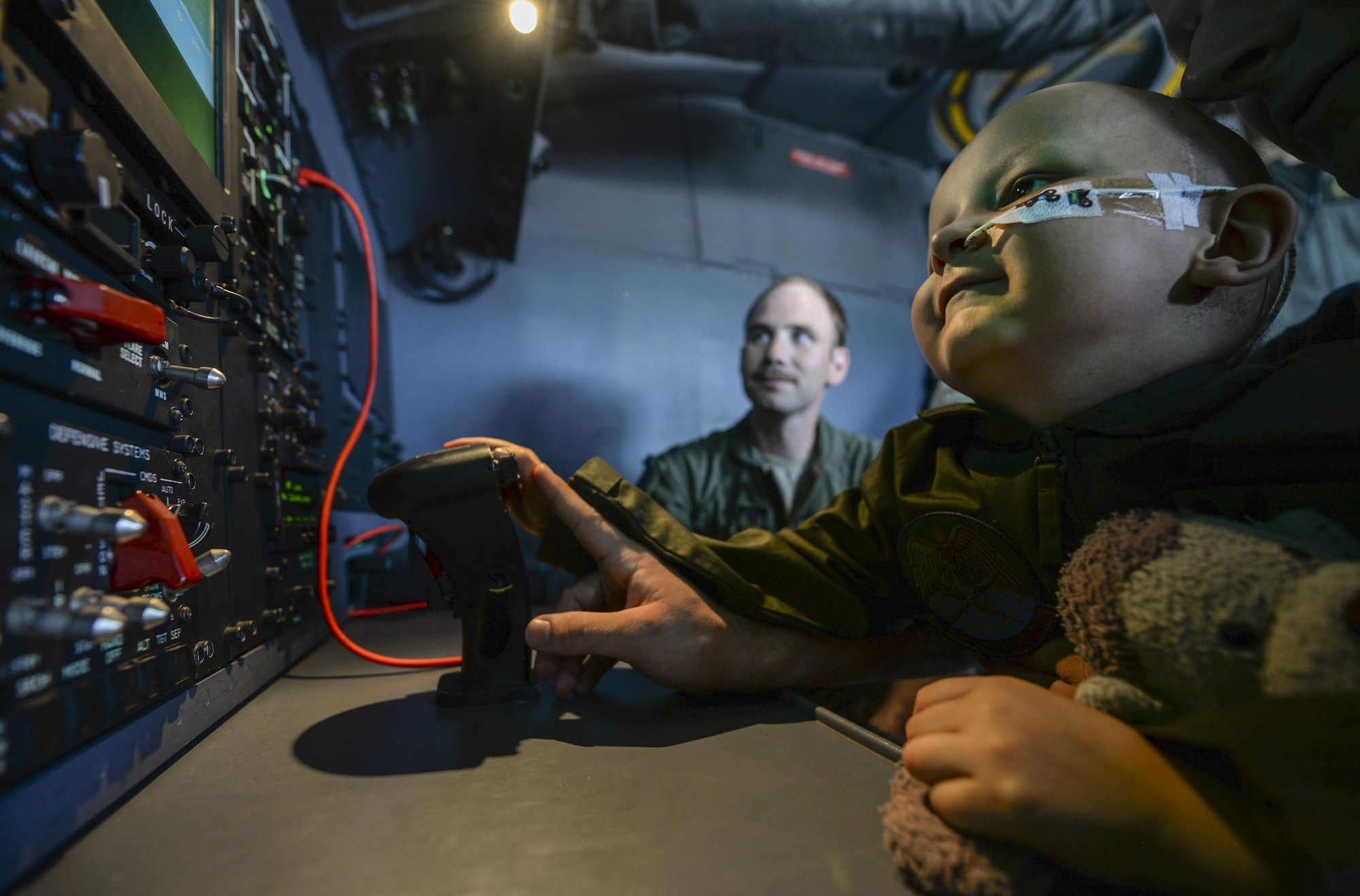 Jay Davidson moves an electro-optical infrared camera on an MC-130J Commando II with the help of his father, Martin, during a Pilot for a Day visit July 7, 2017, at RAF Mildenhall, England. Jay was diagnosed with high-risk medulloblastoma in January 2017. After seven months of chemotherapy, Jay’s doctors told him the brain tumors have gone into remission. (U.S. Air Force photo by Staff Sgt. Micaiah Anthony)