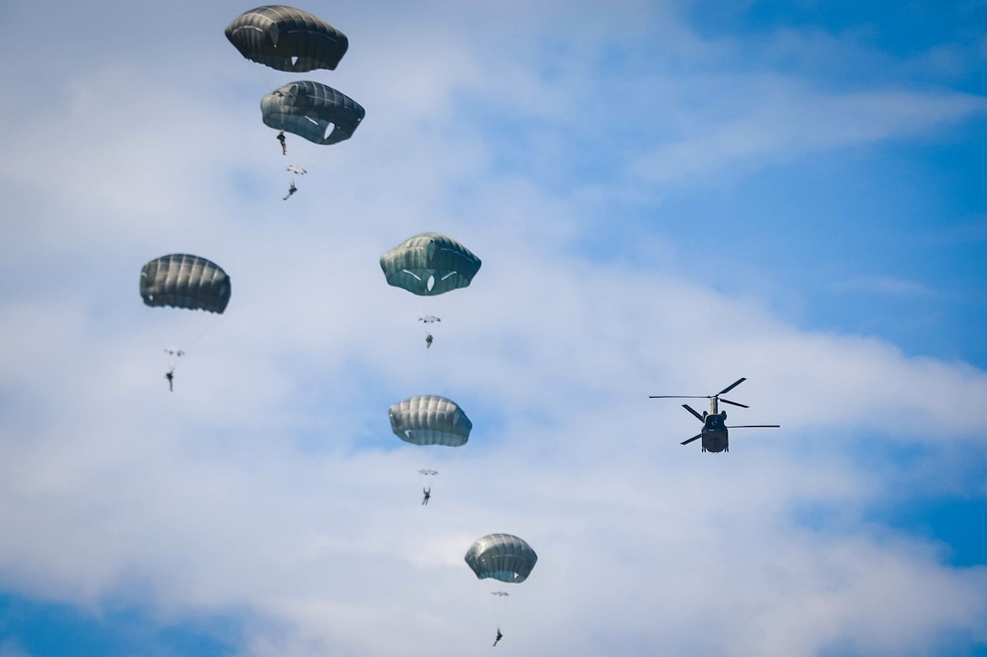 Paratroopers fill the sky with parachutes after jumping from a CH-47 Chinook helicopter during airborne operations over Sicily drop zone at Fort Bragg, N.C., July 6, 2017. Army photo by Sgt. Steven Galimore
