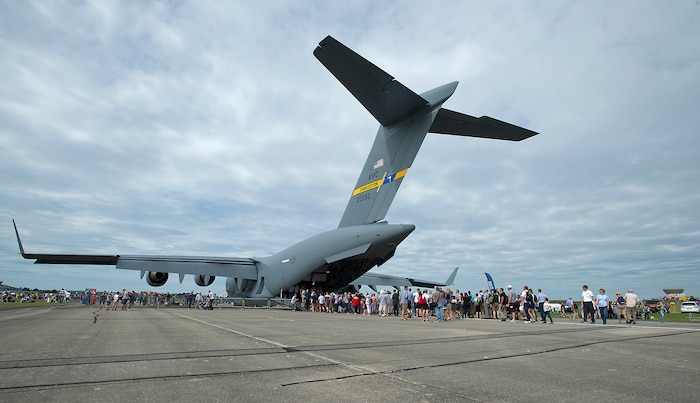 Hundreds of spectators line up to see the inside of a Joint Base Charleston C-17 Globemaster III at the Yeovilton International Air Day at Royal Naval Air Station, U.K. Citizen Airmen from the 701st Airlift Squadron set the bar high by flying the first C-17 low-level pass through the “Mach Loop” and captured another win for their static display at the the air show Friday and Saturday. (U.S. Air Force Photo \ Tech. Sgt. Bobby Pilch)