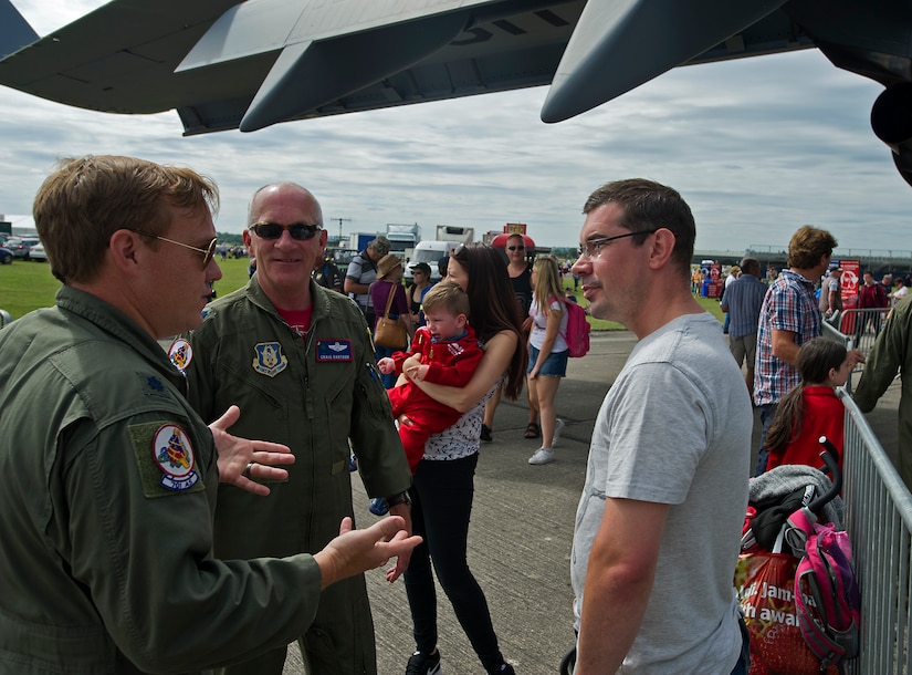 Lt. Col. Mike Parker and Lt. Col. Stephen Bartosh, 701st Airlift Squadron talk with John Baldry, Ultimate Shot Aerial Photography,  at the Yeovilton International Air Day at Royal Naval Air Station, U.K. Citizen Airmen from the 701st Airlift Squadron set the bar high by flying the first C-17 low-level pass through the “Mach Loop” and captured another win for their static display at the the air show Friday and Saturday. (U.S. Air Force Photo \ Tech. Sgt. Bobby Pilch)