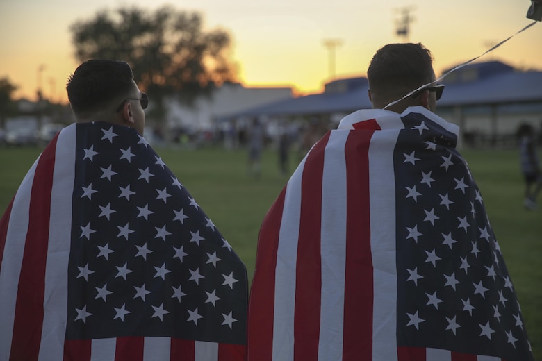 Two Marine Corps Air Ground Combat Center Marines display their patriotism by adorning the national colors during the annual Twentynine Palms Independence Day celebration in Luckie Park, Twentynine Palms, Calif., July 4, 2017. The event included food vendors, a face painting booth and live entertainment, followed by a spectacular firework show. (U.S. Marine Corps photo by Lance Cpl. Christian Lopez)
