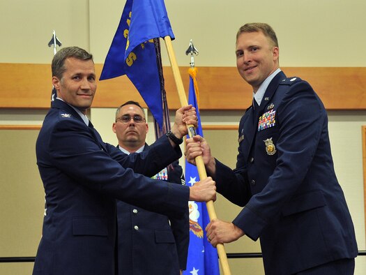 Lt. Col. Alex Mignery, right, accepts command of the 341st Civil Engineer Squadron from Col. Marcus Glenn, 341st Mission Support Group commander, July 7, 2017, at Malmstrom Air Force Base, Mont. Master Sgt. Paul Watts, 341st CES first sergeant, looks on. (U.S. Air Force photo/John Turner)