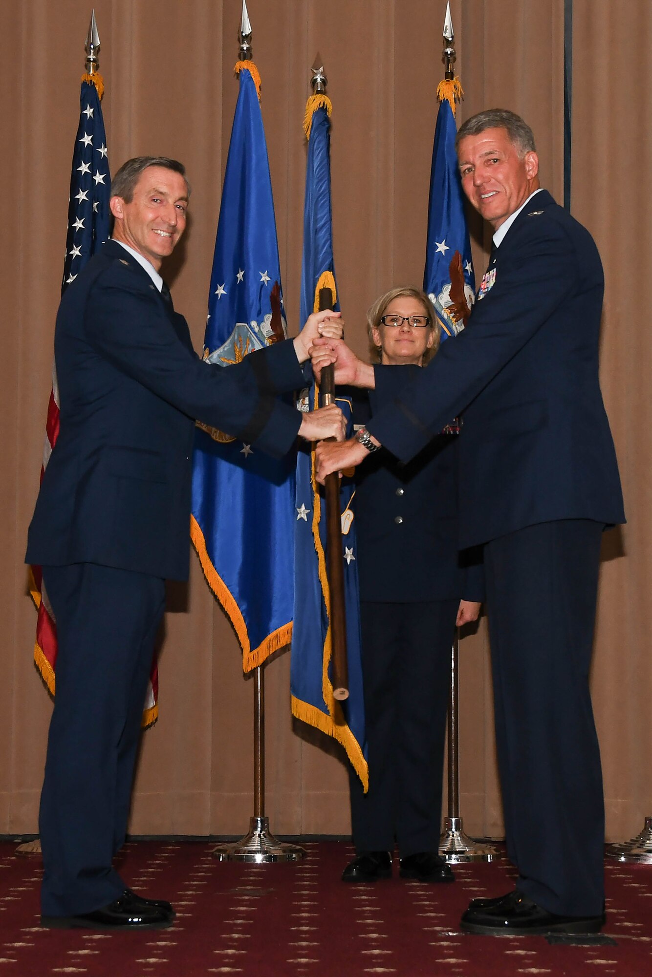 U.S. Air Force Maj. Gen. Bruce Miller, 10th Air Force commander, passes the wing guidon to Colonel Robert VanHoy II during the 307th Bomb Wing change of command ceremony July 8, 2017 at Barksdale Air Force Base, La.  As the flag is exchanged, the authority and responsibility for the 307th Bomb Wing mission and its personnel is transferred. VanHoy was formerly the commander for the 93rd Bomb Squadron and has several years of experience within the wing. (U.S. Air Force photo by Staff Sgt. Callie Ware/Released)