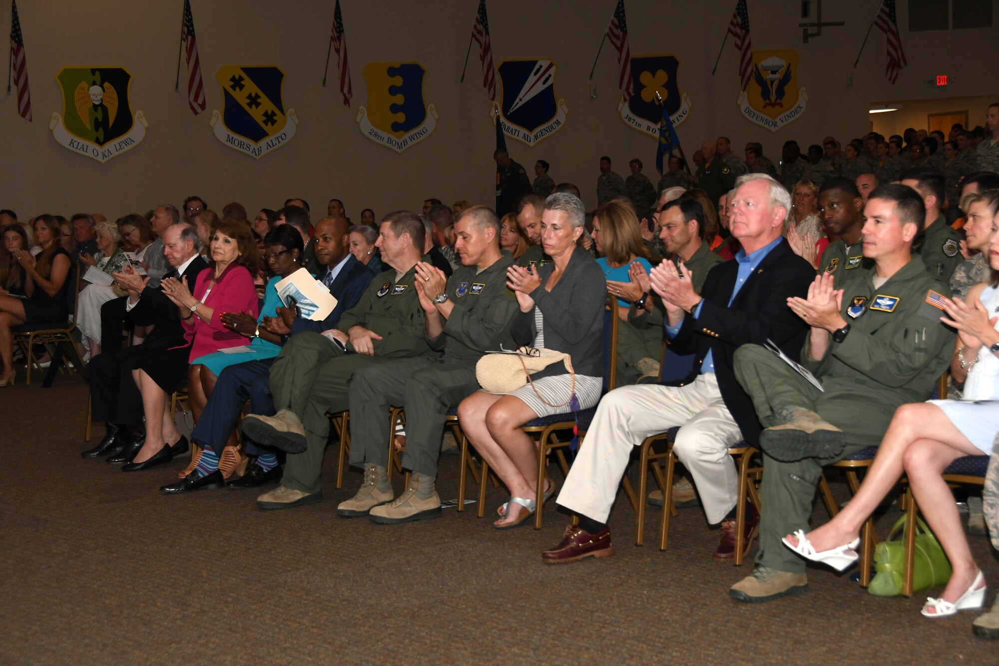 Distinguished guests and visitors applaud Colonel Robert VanHoy II as he assumes command of the 307th Bomb Wing July 8, 2017 at Barksdale Air Force Base, La. VanHoy was formally the commander for the 93rd Bomb Squadron and has several years of experience within the wing. (U.S. Air Force photo by Staff Sgt. Callie Ware/Released)