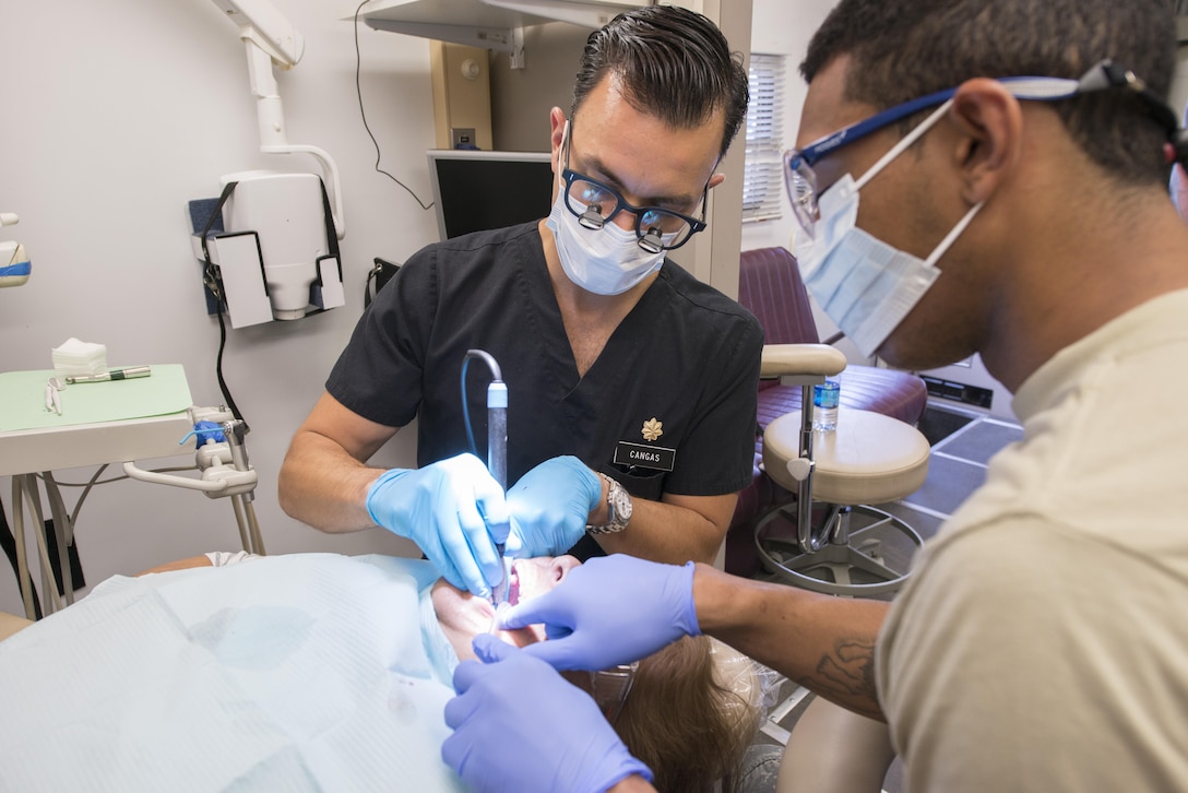 Maj. Jose Cangas, left, an Army Reserve dentist with the 7458th Medical Backfill Battalion, and Sgt. Adam Mosley, a dental assistant with the 7226th Medical Support Unit, clean the teeth of a patient during an Innovative Readiness Training mission in Laredo, Texas, June 21, 2017. Born and raised in El Paso, a similar border city located in west Texas, Cangas along with other Reserve Soldiers traveled to Laredo to treat hundreds of people living in low-income border communities as part of the two-week mission, which concluded Saturday. (Photo Credit: Sean Kimmons)
