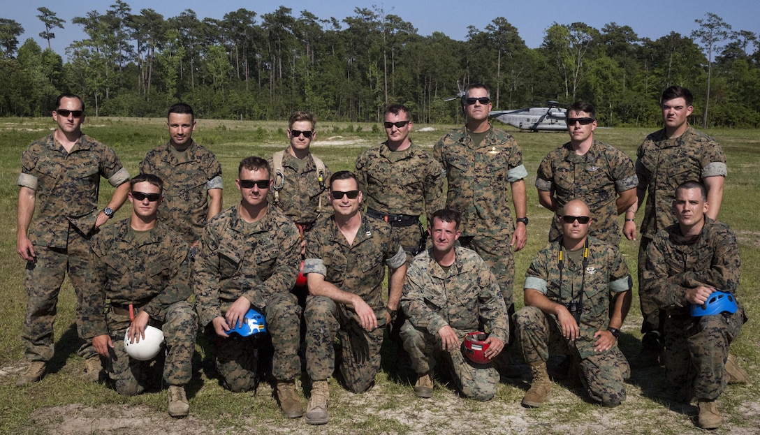 Marines gather in front of a CH-53 Super Stallion at Landing Zone Vulture after rappelling during a ceremony at Stone Bay, a Camp Lejeune satellite training area, N.C., May 17, 2017.  The ceremony marks the reopening of Landing Zone Vulture, which closed Sept. 2, 2015 after a CH-53 crashed resulting in the death of one Marine.  The instructors took the opportunity to memorialize their fallen Marine, Staff Sgt. Jonathan Lewis, through the sustainment rappel. The Marines are with EOTG, II Marine Expeditionary Force Headquarters Group.