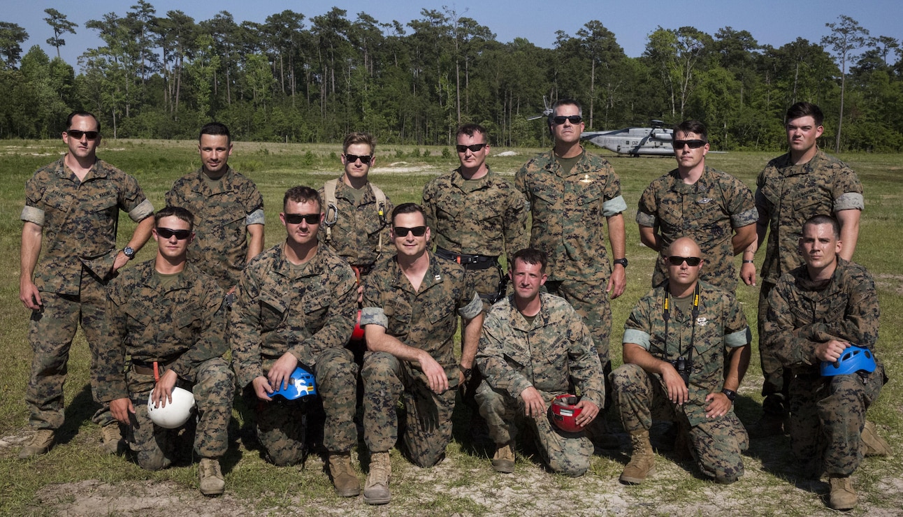 Marines gather in front of a CH-53 Super Stallion at Landing Zone Vulture after rappelling during a ceremony at Stone Bay, a Camp Lejeune satellite training area, N.C., May 17, 2017.  The ceremony marks the reopening of Landing Zone Vulture, which closed Sept. 2, 2015 after a CH-53 crashed resulting in the death of one Marine.  The instructors took the opportunity to memorialize their fallen Marine, Staff Sgt. Jonathan Lewis, through the sustainment rappel. The Marines are with EOTG, II Marine Expeditionary Force Headquarters Group.