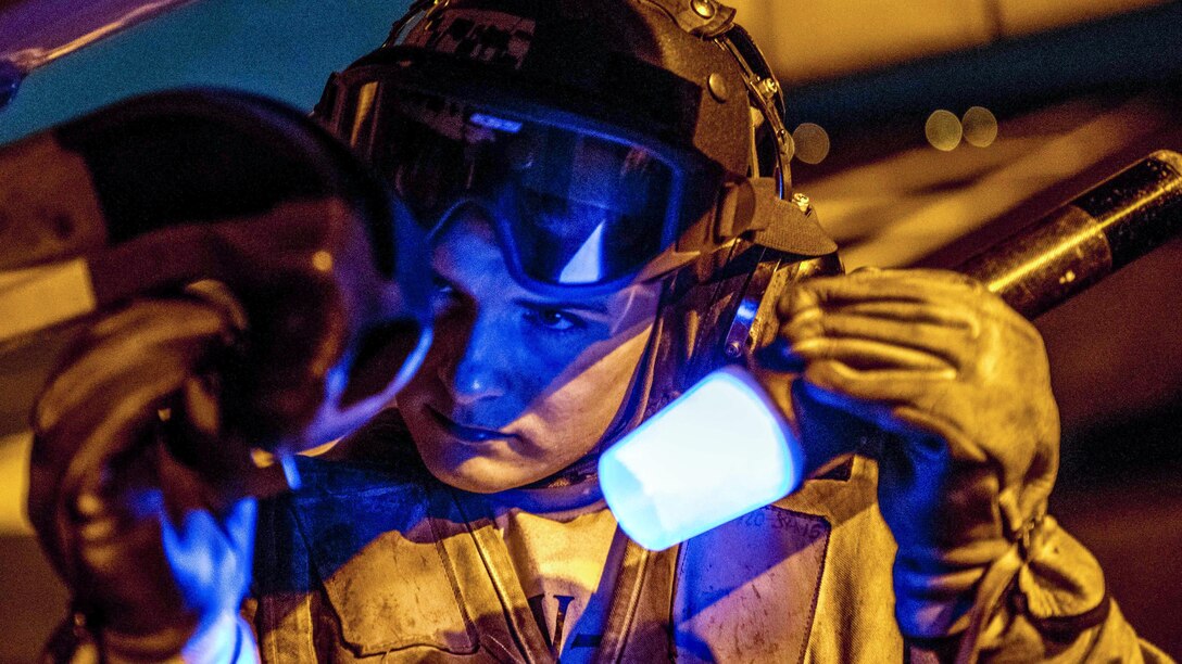 A sailor inspects an E-2C Hawkeye early warning and attack aircraft aboard the aircraft carrier USS George H.W. Bush in the Mediterranean Sea, July 8, 2017. The ship and its carrier strike group are conducting naval operations in the U.S. 6th Fleet area of responsibility to support U.S. national security interests in Europe and Africa. Navy photo by Petty Officer 3rd Class Daniel Gaither