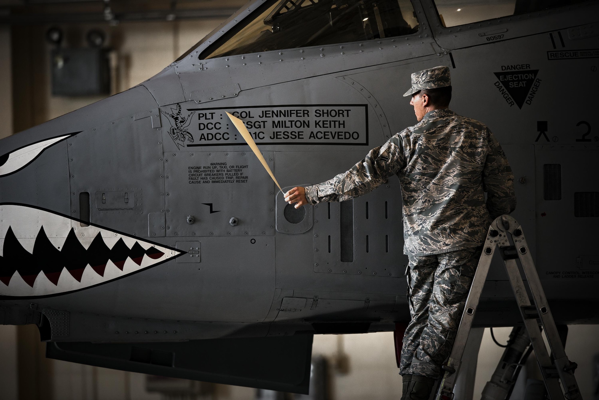 Airman 1st Class Jesse Acevedo, 75th Aircraft Maintenance Unit crew chief, reveals a name plate for Col. Jennifer Short, 23d Wing commander, during a change of command ceremony, July 10, 2017, at Moody Air Force Base, Ga. This ceremony marked the first time a female will command the unit and the first time a fighter pilot will command the 23d Wing since its reactivation at Moody in 2006. (U.S. Air Force photo by Staff Sgt. Ryan Callaghan)