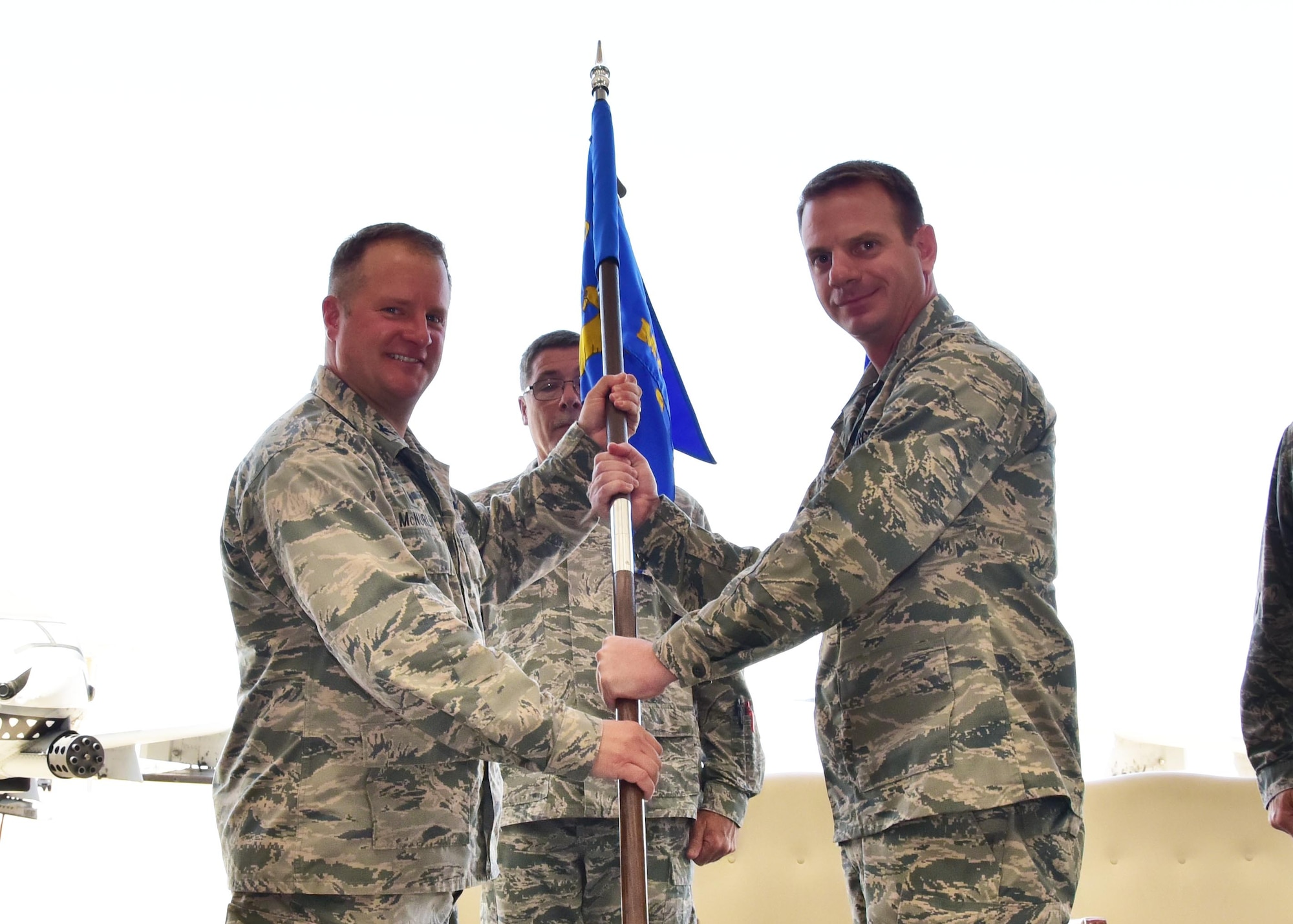 Col. Thomas McNurlin, 924th Fighter Group commander, hands a guidon to Maj. Bobby Cheek who takes command of the 924th Maintenance Squadron July 9 during a change of command ceremony at Davis-Monthan Air Force Base, Ariz. (U.S. Air Force photo by Tech. Sgt. Louis Vega Jr.)