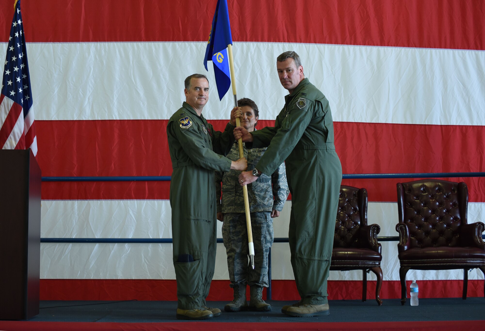 Col. Gregory Jones, 301st Fighter Wing commander, passes the operations group guidon July 8, 2017, to its new commander, Col. David Sundlov, during an assumption of command ceremony at Naval Air Station Fort Worth Joint Reserve Base, Texas. After becoming group commander, Sundlov addressed guests and Airmen saying he looked forward to accomplishing the group's mission of high-level combat-readiness training, immediate mobilization, F-16C+ Fighting Falcon employment and worldwide deployment while maintaining constant vigilance at home and abroad. (U.S. Air Force photo by Tech. Sgt. Jeremy Roman) 