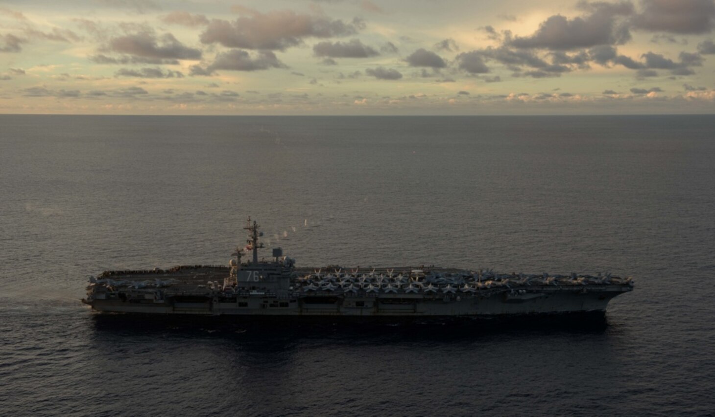 Sailors observe a coordinated live-fire gunnery exercise from the flight deck of the aircraft carrier USS Ronald Reagan (CVN 76), June 29, 2017. The ship is the flagship of Carrier Strike Group 5, providing a combat-ready force that protects and defends the collective maritime interests of its allies and partners in the Indo-Asia-Pacific region.