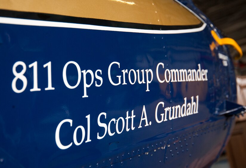 The 811th Operations Group unveiled incoming commander Col. Scott A. Grundahl’s name on a UH-1N Iroquois helicopter during the group’s change of command ceremony at Joint Base Andrews, Md., July 7, 2017. The group consists of the 811th Operations Support Squadron and the 1st Helicopter Squadron both of which provide the National Capital Region with continuous rotary-wing contingency response. (U.S. Air Force photo by Christopher Hurd)