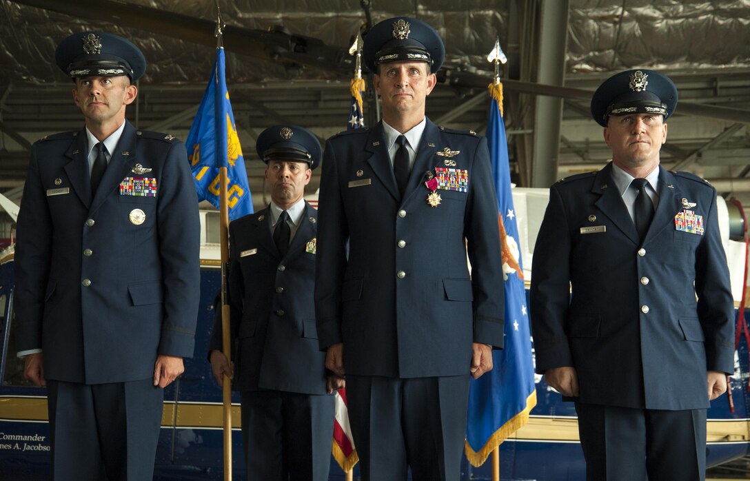 Col. E. John Teichert, 11th Wing and Joint Base Andrews commander, left, Col. Fred C. Koegler III, center, and Col. Scott A. Grundahl, right, stand during the 811th Operations Group change of command at Joint Base Andrews, Md., July 7, 2017. Grundahl relieved Koegler as commander of the 811th OG. The group consists of the 811th Operations Support Squadron and the 1st Helicopter Squadron both of which provide the National Capital Region with continuous rotary-wing contingency response.  (U.S. Air Force photo by Christopher Hurd)