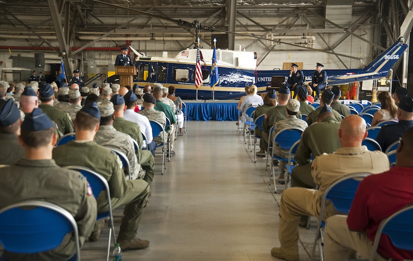 Audience members look on as Col. E. John Teichert, 11th Wing and Joint Base Andrews commander, gives his opening remarks during the 811th Operations Group change of command ceremony at Joint Base Andrews, Md., July 7, 2017. Col. Scott A. Grundahl relieved Col. Fred C. Koegler III as commander of the 811th OG. The group consists of the 811th Operations Support Squadron and the 1st Helicopter Squadron both of which provide the National Capital Region with continuous rotary-wing contingency response. (U.S. Air Force photo by Christopher Hurd)