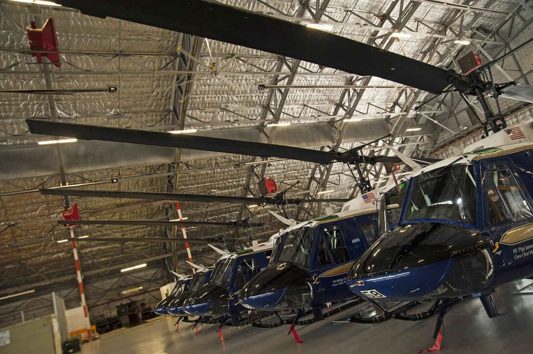 Five UH-1N Iroquois helicopters sit in hangar one during the 811th Operations Group change of command ceremony at Joint Base Andrews, Md., July 7, 2017. Col. Scott A. Grundahl relieved Col. Fred. C. Koegler III as 811th OG commander. The group consists of the 811th Operations Support Squadron and the 1st Helicopter Squadron both of which provide the National Capital Region with continuous rotary-wing contingency response.  (U.S. Air Force photo by Christopher Hurd)
