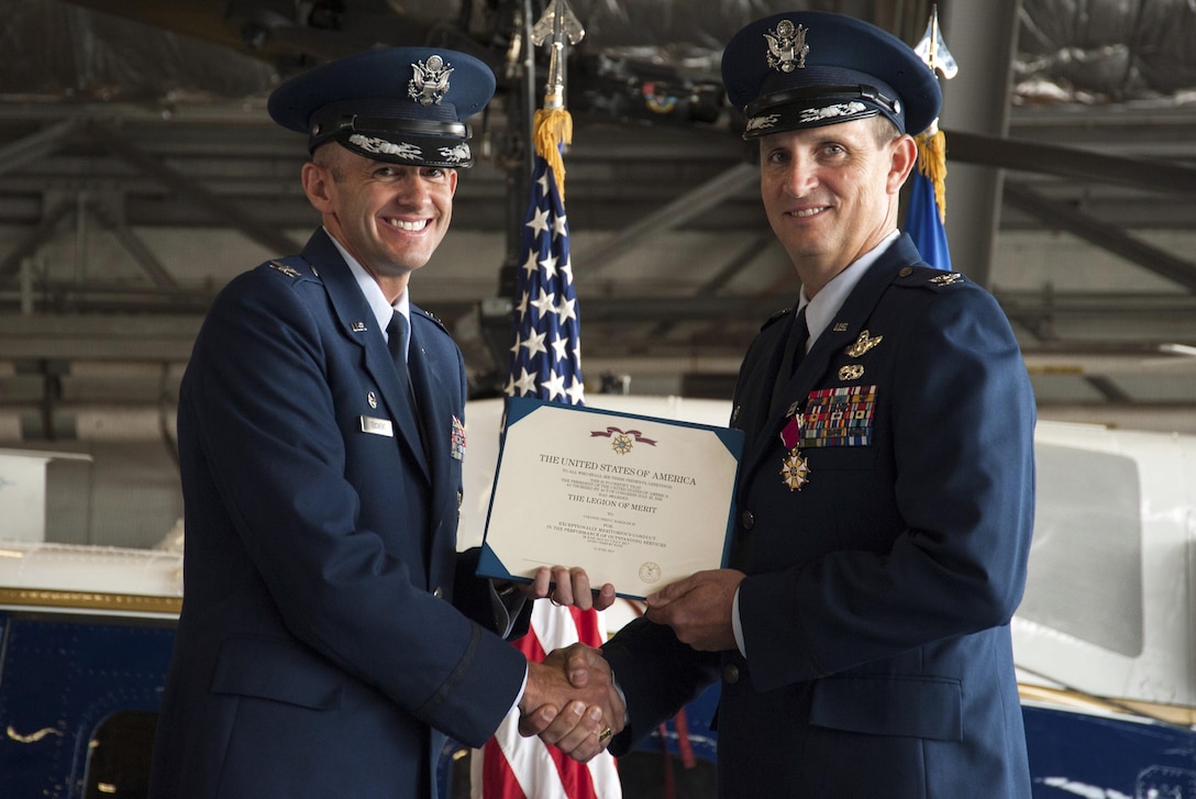 Col. E. John Teichert, 11th Wing and Joint Base Andrews commander, left, presents outgoing 811th Operations Group Commander Col. Fred C. Koegler III with the Legion of Merit award during the 811th OG change of command ceremony at Joint Base Andrews, Md., July 7, 2017. Koegler was presented the award for his exceptional meritorious conduct as commander. The group consists of the 811th Operations Support Squadron and the 1st Helicopter Squadron both of which provide the National Capital Region with continuous rotary-wing contingency response. (U.S. Air Force photo by Christopher Hurd)