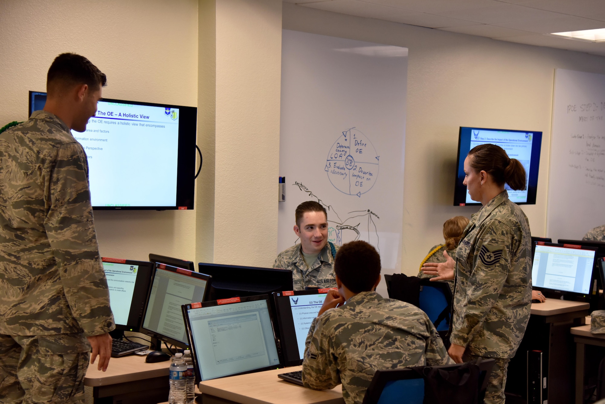 U.S. Air Force Tech. Sgt. Stephanie Godsey, 315th Training Squadron instructor supervisor, speaks with students at the Di Tommaso Hall on Goodfellow Air Force Base, Texas, June 21, 2017. The classroom featured is one of the next generation classrooms, where groups of two to three students get a television they can share for classwork and a white board to take notes on. (U.S. Air Force photo by Staff Sgt. Joshua Edwards/Released)