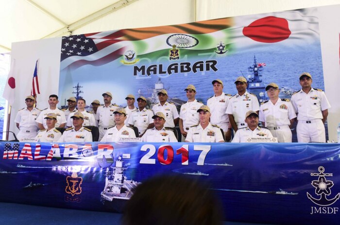 Leaders from U.S., Indian, and Japanese maritime forces pose for a photo after a press conference aboard the INS Jalashwa (LPD 41) as part of the opening ceremonies of exercise Malabar 2017. Malabar 2017 is the latest in a continuing series of exercises between the Indian Navy, Japan Maritime Self Defense Force and the U.S. Navy that has grown in scope and complexity over the years to address the variety of shared threats to maritime security in the Indo-Asia Pacific.