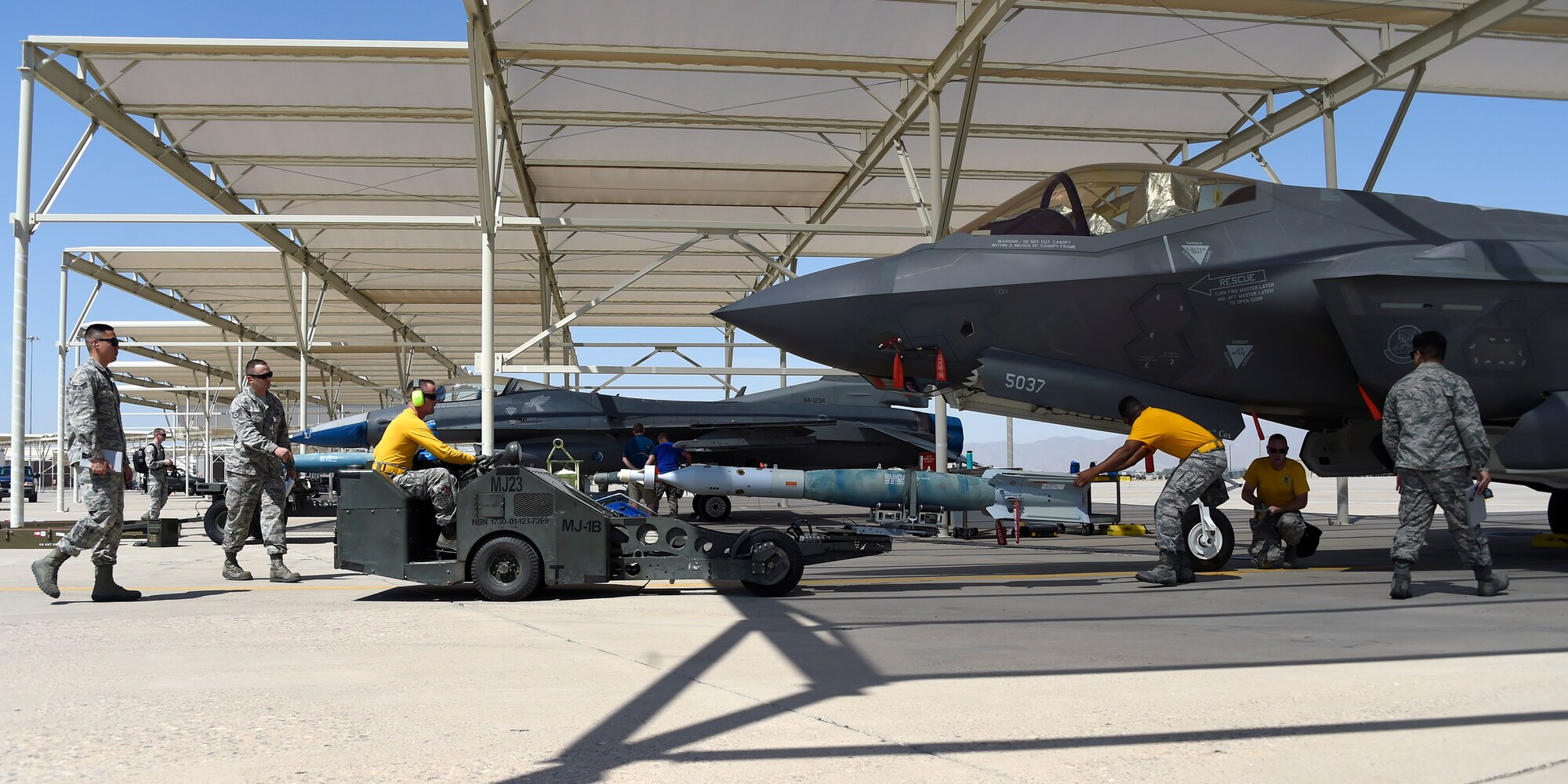 Members of the 61st Aircraft Maintenance Unit load crew team prepare to load an AIM 9 sidewinder missile inside an F-35 Lightning II during a load crew competition at Luke Air Force Base, Ariz., July 7, 2017. The load crew competition is designed to encourage friendly competition among load crew members and enable them to display the high skill level at which they operate. (U.S. Air Force photo by Senior Airman Devante Williams) 