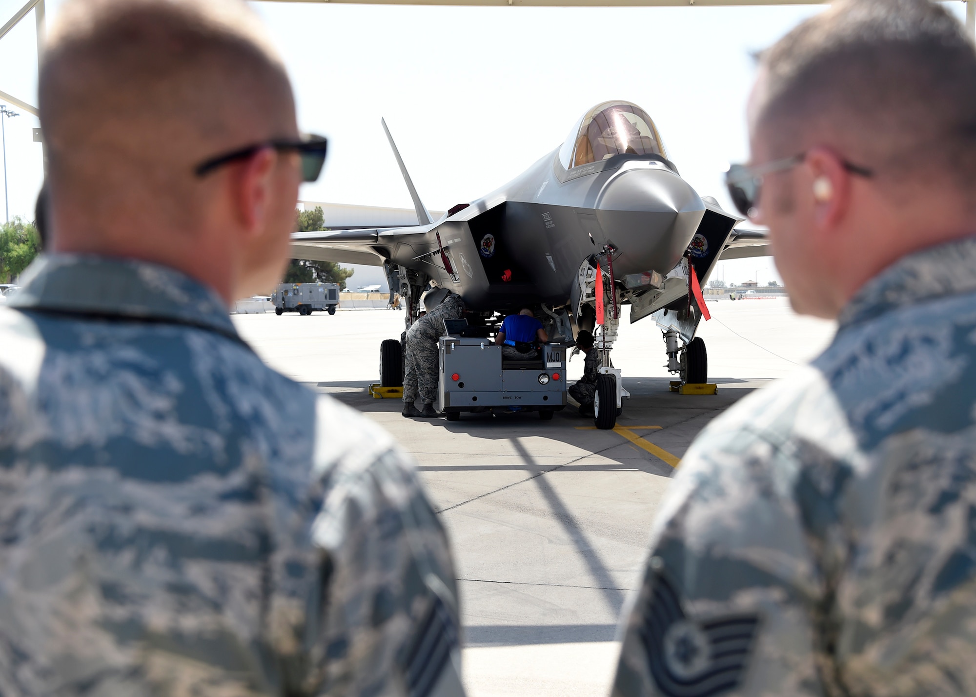 Members of the 62nd Aircraft Maintenance Unit load crew team secure a weapon during a load crew competition at Luke Air Force Base, Ariz., July 7, 2017. The purpose of the competition was to see which team loads weapons onto their respective aircraft earning the fastest time with the fewest errors. (U.S. Air Force photo by Senior Airman Devante Williams)