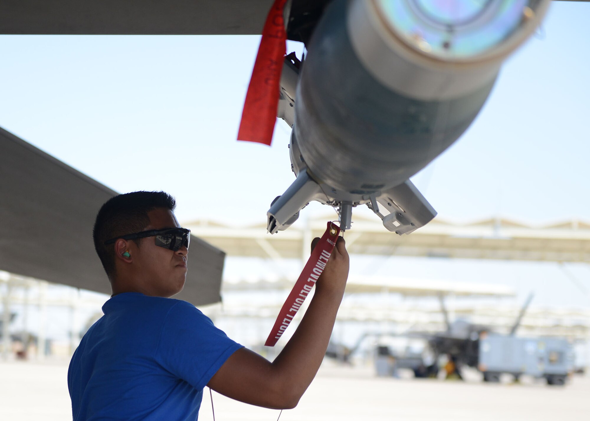 Airman 1st Class Julian Domingo, 309th Aircraft Maintenance Unit load crew member, tags a GBU-12 Paveway II during the quarterly load crew competition at Luke Air Force Base, Ariz., July 7, 2017. The goal of the competition was to load two GBU-12s in under 30 minutes. (U.S. Air Force photo by Senior Airman James Hensley)