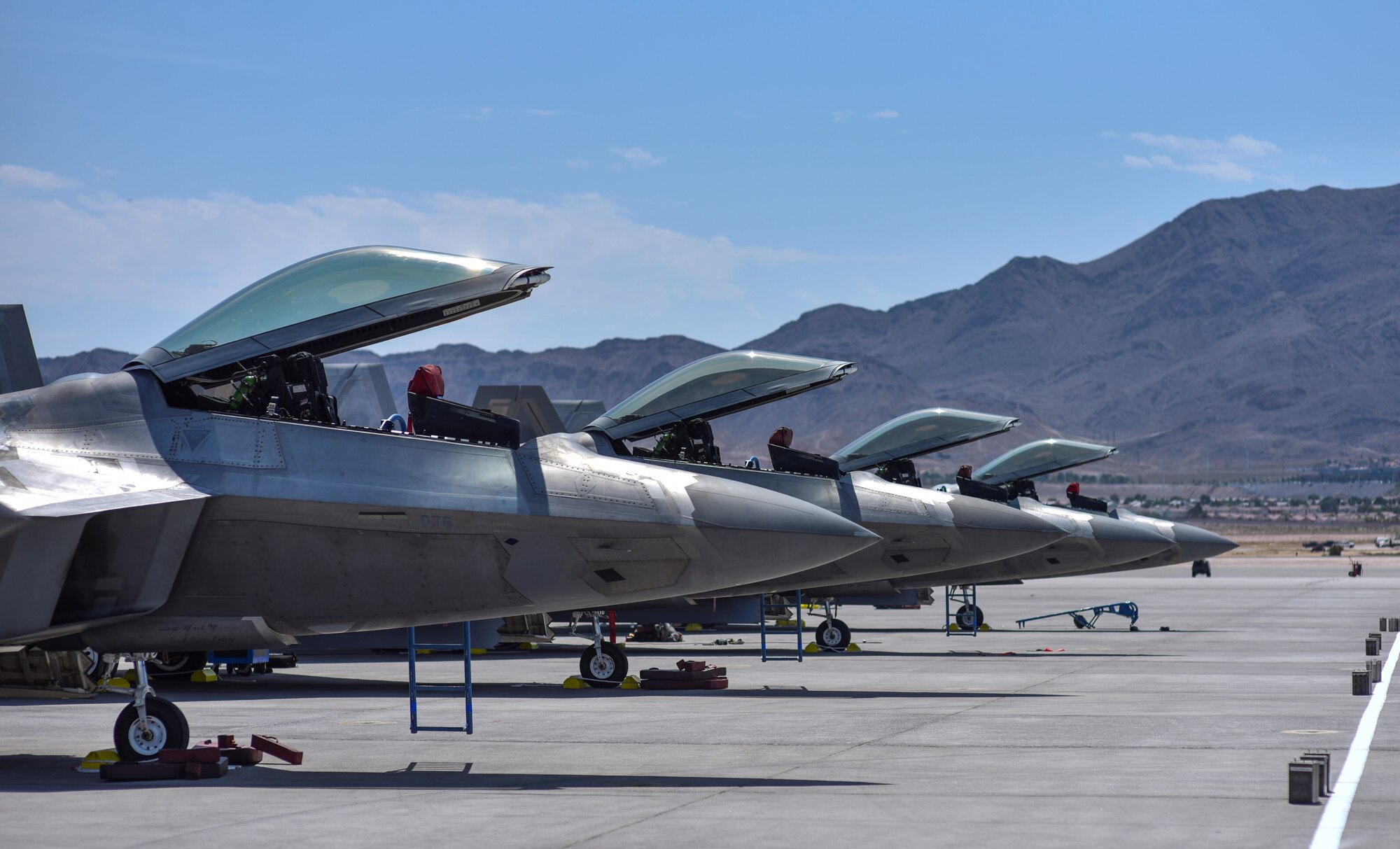 Four F-22 Raptors assigned to the 95th Fighter Squadron at Tyndall Air Force Base, Fla., sit on the flightline at Nellis Air Force Base, Nev., in preparation for Red Flag 17-3 July 7, 2017. This exercise gives Airmen an opportunity to experience realistic combat scenarios to prepare and train them in the event of future conflicts or war. (U.S. Air Force photo by Senior Airman Dustin Mullen/Released)