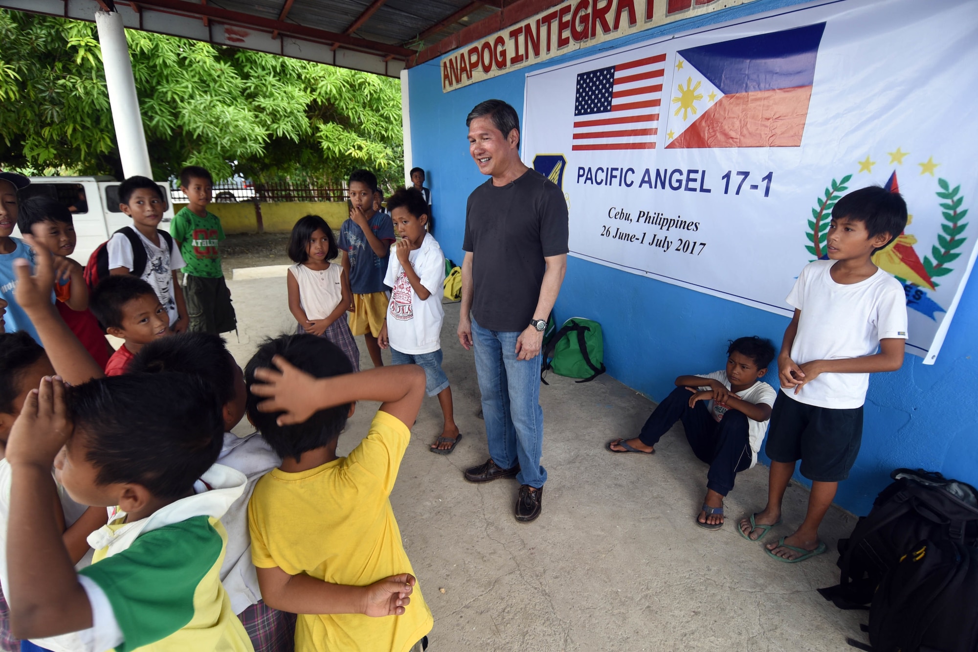 Dr. John Cinco, founder of Pacific Angel (PACANGEL), talks with the children of Anapog Integrated School during PACANGEL 2017 in San Remigio, Northern Cebu Province, Philippines, June 29, 2017. PACANGEL is a multilateral humanitarian assistance civil military engagement, which improves military-to-military partnerships in the Pacific while also providing medical health outreach, civic engineering projects and subject matter exchanges among partner forces. (U.S. Air Force photo/Master Sgt. Jeff Andrejcik)