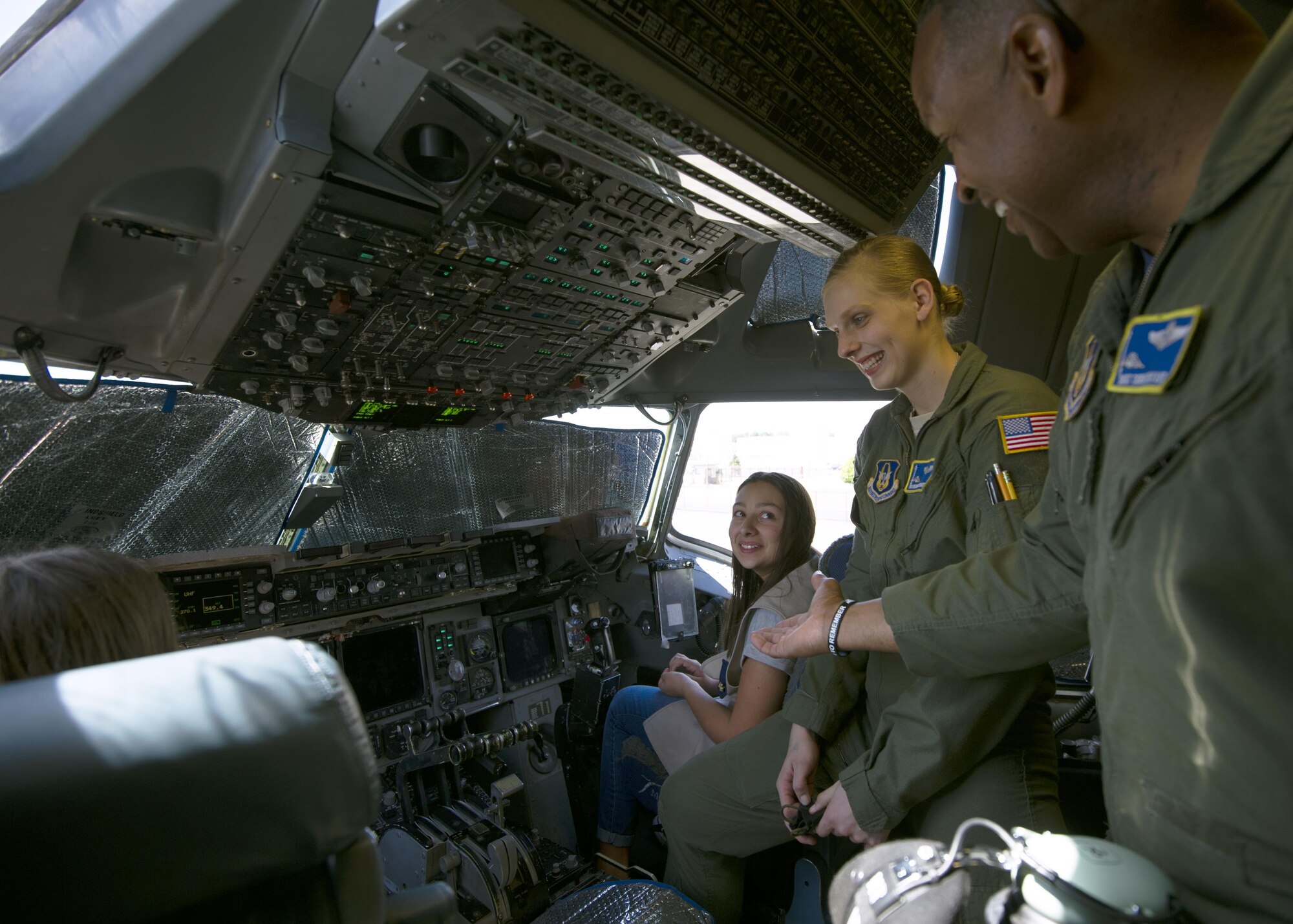 Senior Master Sgt. Derek Bryant, a loadmaster with the 446th Operations Group, and Senior Airman Bridgette Johnson, 728th Airlift Squadron loadmaster, show members of Girl Scout Troop 40931 the flight deck of a C-17 Globemaster III July 9, 2017, at McChord Field. During the visit, seven girl scouts were able to tour the 446th AW, a C-17, control tower, and learned survival tips from a Survival, Evasion, Resistance and Escape, instructor. (U.S. Air Force photo by Tech. Sgt. Bryan Hull)
