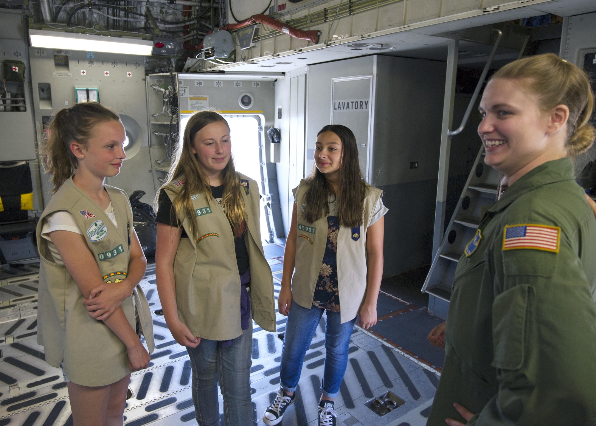 Staff Sgt. Jennifer Patterson, a 728th Airlift Squadron loadmaster, describes the role of a loadmaster aboard a C-17 Globemaster III to Girl Scouts July 9, 2017, at McChord Field. During the visit, seven girl scouts were able to tour the 446th AW, a C-17 Globemaster III, control tower, and learned survival tips from a Survival, Evasion, Resistance and Escape, instructor. (U.S. Air Force photo by Tech. Sgt. Bryan Hull)