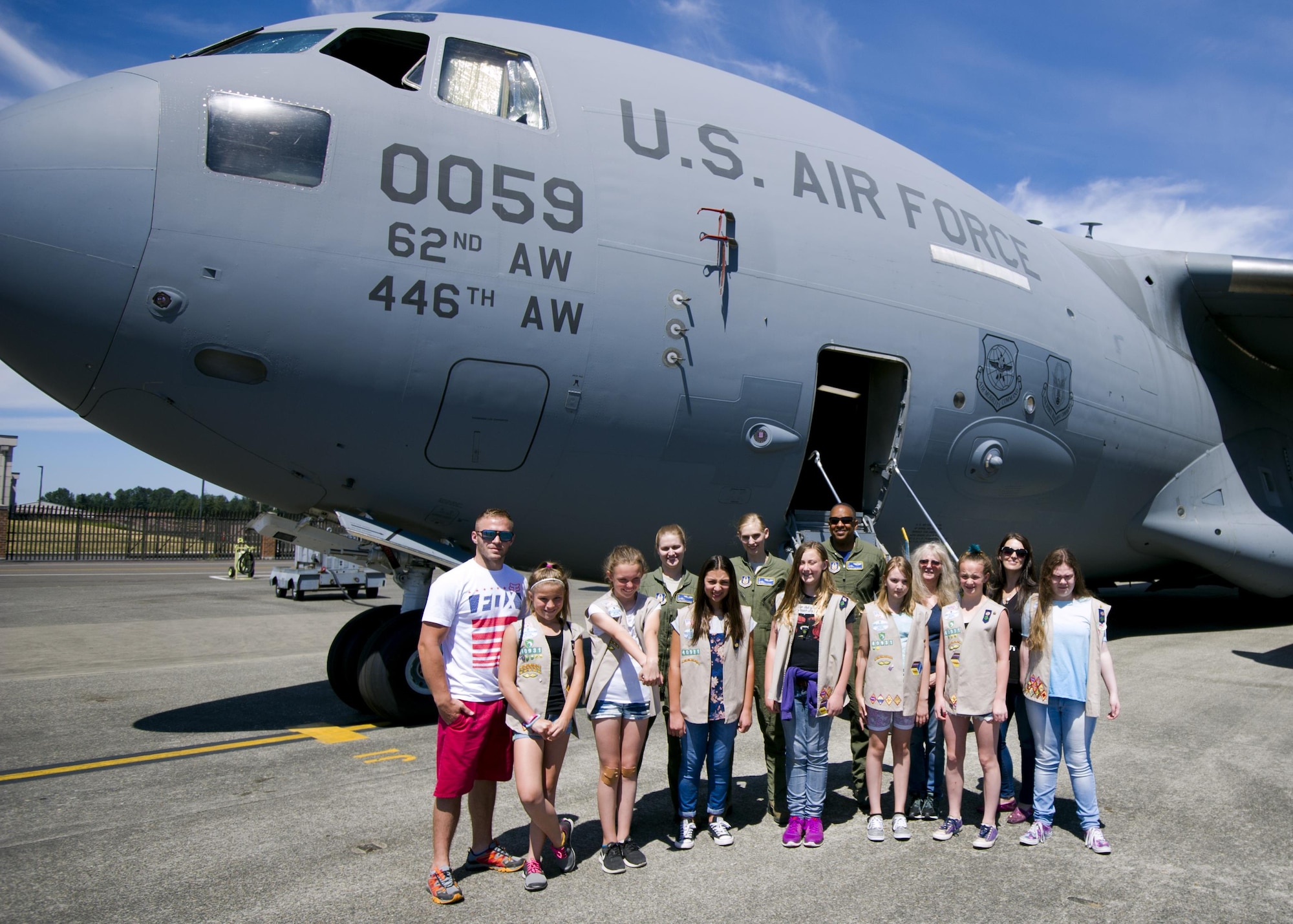 Members of the 446th Airlift Wing and a local Girl Scout troop pose in front of a C-17 Globemaster III at McChord Field July 9, 2017, during a tour of the base. During the visit, several girl scouts were able to tour the 446th AW, a C-17, control tower, and learned survival tips from a Survival, Evasion, Resistance and Escape, instructor. (U.S. Air Force photo by Tech. Sgt. Bryan Hull)