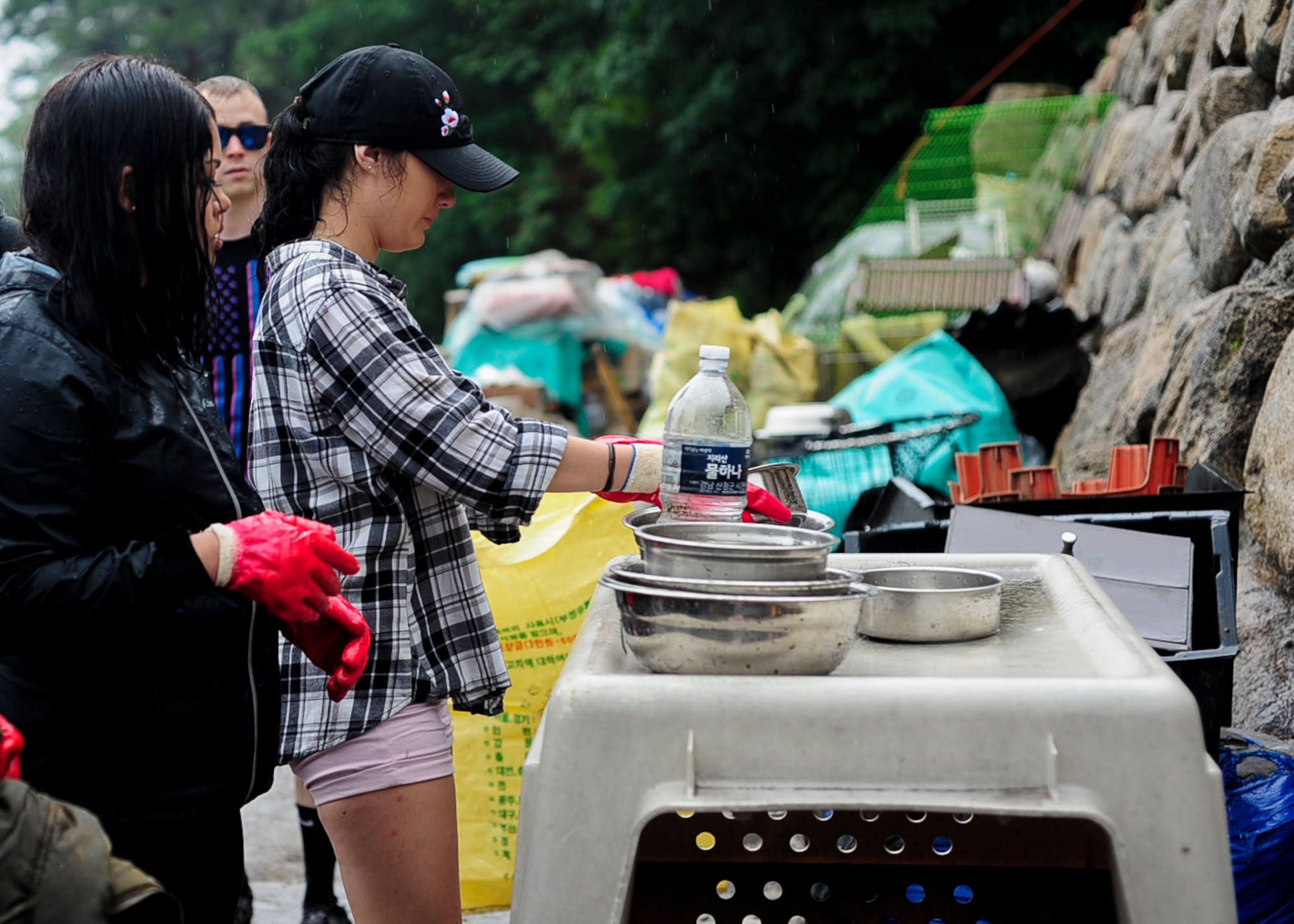 U.S. Air Force Airmen assigned to Kunsan Air Base, Republic of Korea and other volunteers wash out water bowls while on a volunteer trip to an animal shelter in Daegu, RoK, July 8, 2017. The trip, sponsored by Kunsan Patriots for Animal Welfare and Scholarships, or Kunsan P.A.W.S., was the first of many to the no-kill shelter in Daegu. (U.S. Air Force photo by Staff Sgt. Victoria H. Taylor)