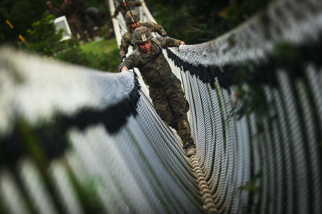 Cpl. Bryan Hernandezrodriguez, a Hialeah, Florida native and rifleman assigned to Bravo Company, 1st Battalion, 3rd Marine Regiment, travels across a rope bridge during the endurance course, aboard Camp Gonzales, Okinawa, Japan, July 7, 2017.The Jungle Warfare Training Center provides individual and unit level training to increase survivability and lethality while operating in a jungle environment. The Hawaii-based battalion is forward deployed to Okinawa, Japan as part of the Unit Deployment Program. (U.S. Marine Corps photo by Cpl. Aaron S. Patterson)