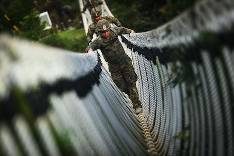 Cpl. Bryan Hernandezrodriguez, a Hialeah, Florida native and rifleman assigned to Bravo Company, 1st Battalion, 3rd Marine Regiment, travels across a rope bridge during the endurance course, aboard Camp Gonzales, Okinawa, Japan, July 7, 2017.The Jungle Warfare Training Center provides individual and unit level training to increase survivability and lethality while operating in a jungle environment. The Hawaii-based battalion is forward deployed to Okinawa, Japan as part of the Unit Deployment Program. (U.S. Marine Corps photo by Cpl. Aaron S. Patterson)