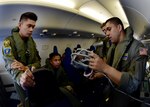 170622-N-QV906-359 CEBU, Philippines (June 22, 2017) Naval Aircrewman Operator 2nd Class Pedro Gonzalez of Combat Air Crew 4 attached to Patrol Squadron 26 (VP-26) demonstrates the emergency oxygen system aboard a P-8 Poseidon aircraft during a demonstration flight for Maritime Training Activity (MTA) Sama Sama 2017, June 22.  MTA Sama Sama is a bilateral maritime exercise between U.S. and Philippine naval forces and is designed to strengthen cooperation and interoperability between the nations' armed forces.  (U.S. Navy photo by Mass Communication Specialist 1st Class Micah Blechner/RELEASED)
