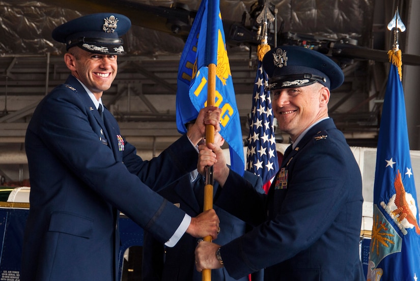 Col. E. John Teichert, 11th Wing and Joint Base Andrews commander, left, presents Col. Scott A. Grundahl with the 811th Operations Group guidon during the 811th OG change of command ceremony on Joint Base Andrews, Md., July 7, 2017. Grundahl relieved Col. Fred. C. Koegler III as commander of the group. The group consists of the 811th Operations Support Squadron and the 1st Helicopter Squadron both of which provide the National Capital Region with continuous rotary-wing contingency response. (U.S. Air Force photo by Christopher Hurd)