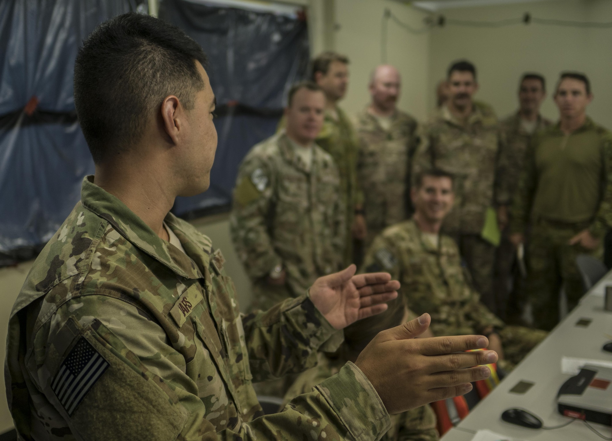 A U.S. Air Force 1st Special Operations Squadron intelligence officer briefs U.S. and Australian partners on the intelligence picture as aircrew and special tactics personnel prepare to execute the warfighting scenario of Talisman Saber 2017, July 10, 2017, at Rockhampton, Australia. Working with the Australian Army’s 6th Aviation and 2nd Commando Regiments, 37th Squadron Royal Australian Air Force, 40th Squadron Royal New Zealand Air Force, U.S. Navy Helicopter Sea Combat Squadron-85 and U.S. Marine Corps 3rd Reconnaissance Battalion provided the 353rd Special Operations Group the opportunity for increased partnership building capacity and interoperability. (U.S. Air Force photo by Capt. Jessica Tait)