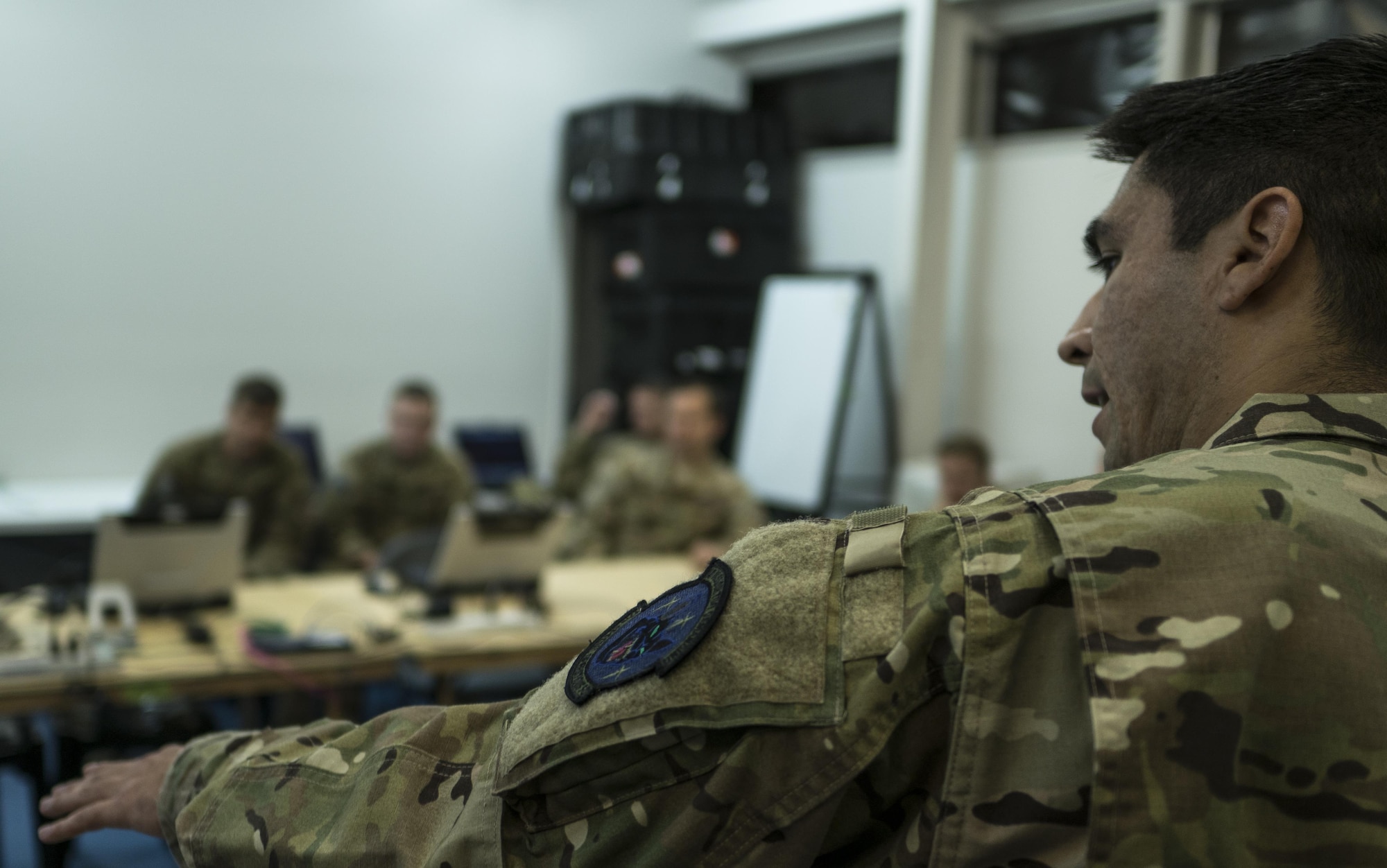 A U.S. Air Force 17th Special Operations Squadron intelligence analyst provides the intel picture of the warfighting scenario to aircrew prior to air operations July 9, 2017, at Rockhampton, Australia. Talisman Saber 2017 provides the relevant training necessary to maintain regional security, peace and stability. (U.S. Air Force photo by Capt. Jessica Tait)