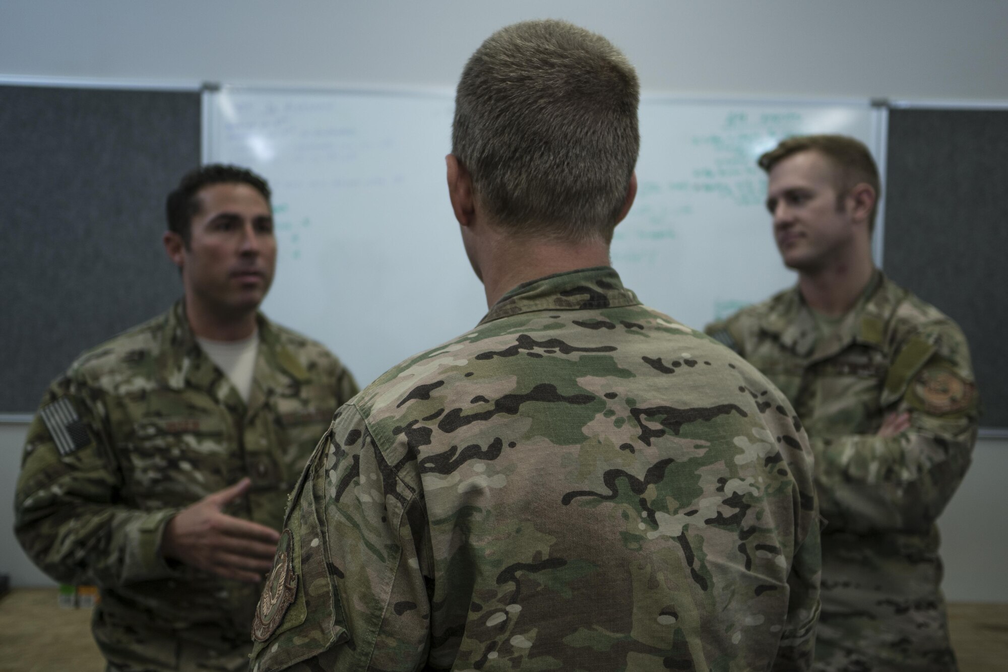 A U.S. Air Force 320th Special Tactics Squadron combat controller and pararescueman ask their intelligence analysist questions about the warfighting scenario in preparation for special operations missions to be conducted during Talisman Saber 2017, July 9, 2017, at Rockhampton, Australia. Talisman Saber 2017 is a biennial military training exercise from 23 June to 25 July throughout various locations in Australia. (U.S. Air Force photo by Capt. Jessica Tait)
