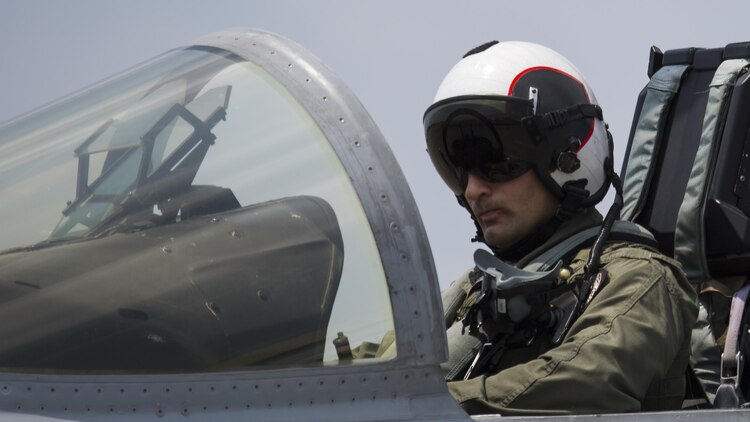 U.S. Marine Corps Maj. Frank Machniak, a pilot with Marine Fighter Attack Squadron (VMFA) 232, prepares to exit an F/A-18C Hornet after landing at Japan Air Self-Defense Force (JASDF) Hyakuri Air Base, Japan, July 7, 2017. VMFA-232 is conducting exercises with the JASDF as part of the Aviation Training Relocation (ATR) Program, The ATR is designed to increase operational readiness and bilateral interoperability between U.S. and Japanese forces. It also reduces noise impact across the country by dispersing unilateral jet-fighter training of U.S. forces in Japan. (U.S. Marine Corps photo by Lance Cpl. Mason Roy)