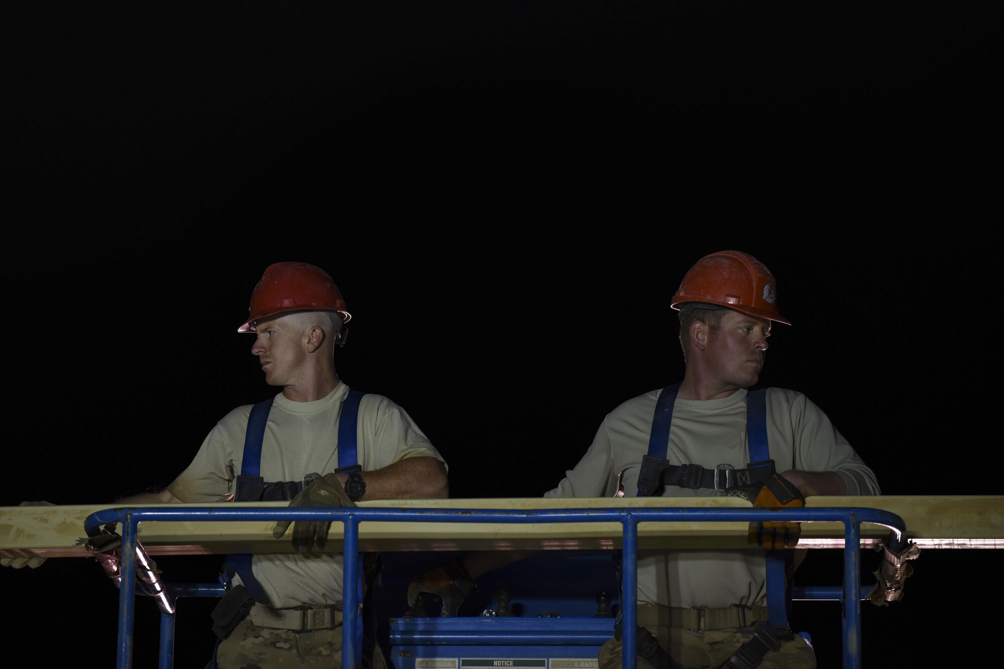 Tech. Sgt. Derek Miller, 557th Expeditionary RED HORSE heating ventilation air conditioning craftsman, left, and Staff Sgt. Shannon Beavin structural craftsman, set up the structural frame of a building face June 27, 2017, in Southwest Asia. Airmen work night shifts due to the extreme temperatures during the day. (U.S. Air Force photo/Senior Airman Damon Kasberg)