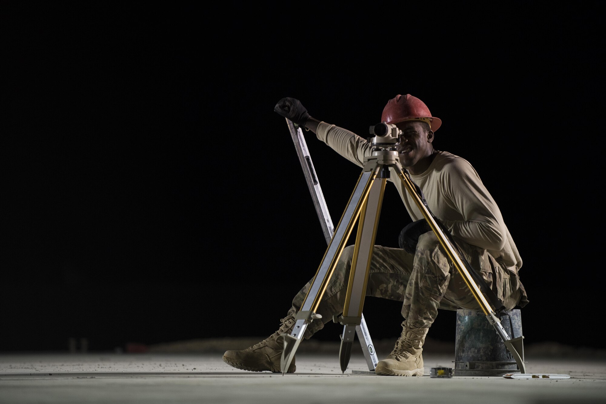 Staff Sgt. Jackie Timmons, 557th Expeditionary RED HORSE structural craftsman, adjusts a laser level to ensure construction is started on the proper elevation June 27, 2017, in Southwest Asia. The squadron provides engineering services throughout the Air Force Central Command area of responsibility, inside and outside the wire. (U.S. Air Force photo/Senior Airman Damon Kasberg)
