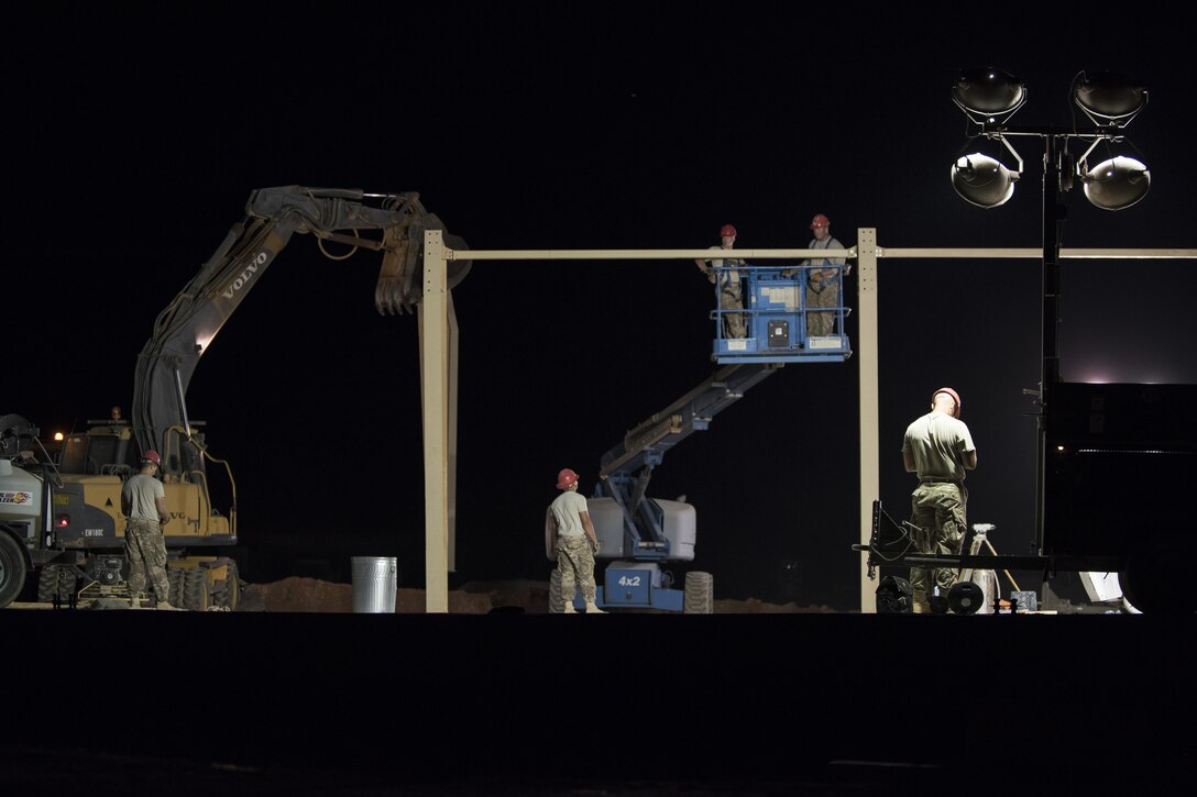 Airmen from the 557th Expeditionary RED HORSE put up a steel frame of a building June 27, 2017, in Southwest Asia. RED HORSE provides self-sustaining engineering operations in assessments, planning, programming, design, heavy construction and repair capabilities, offering flexible options to theater commanders to leverage mission sets that would otherwise not be available. (U.S. Air Force photo/Senior Airman Damon Kasberg)