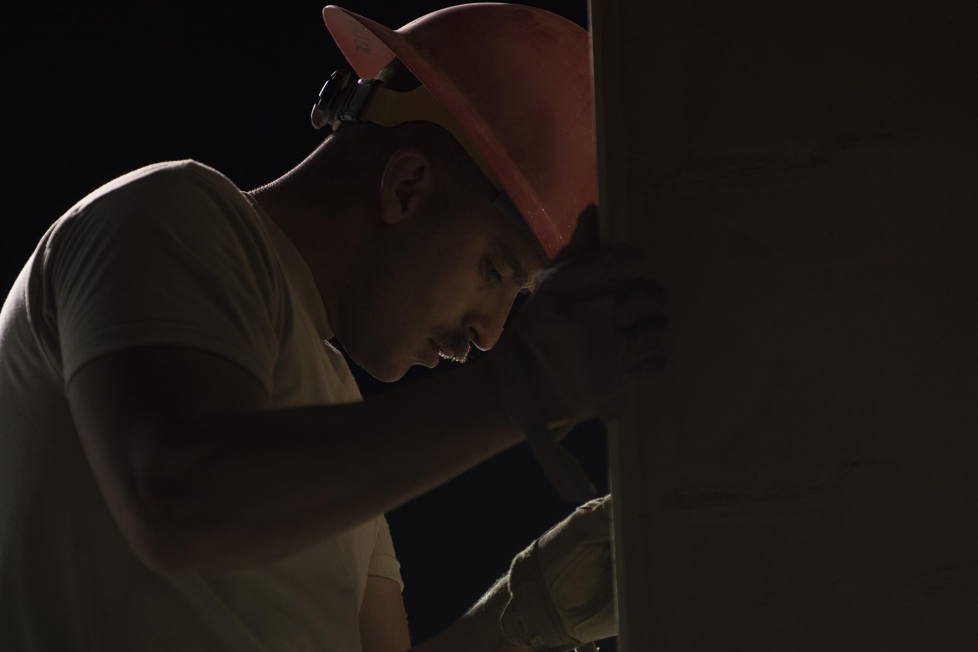 Staff Sgt. Mikeial Chadwick, 557th Expeditionary RED HORSE structural craftsman, helps stand up a vertical column June 27, 2017, in Southwest Asia. Airmen work night shifts due to the extreme temperatures during the day. (U.S. Air Force photo/Senior Airman Damon Kasberg)