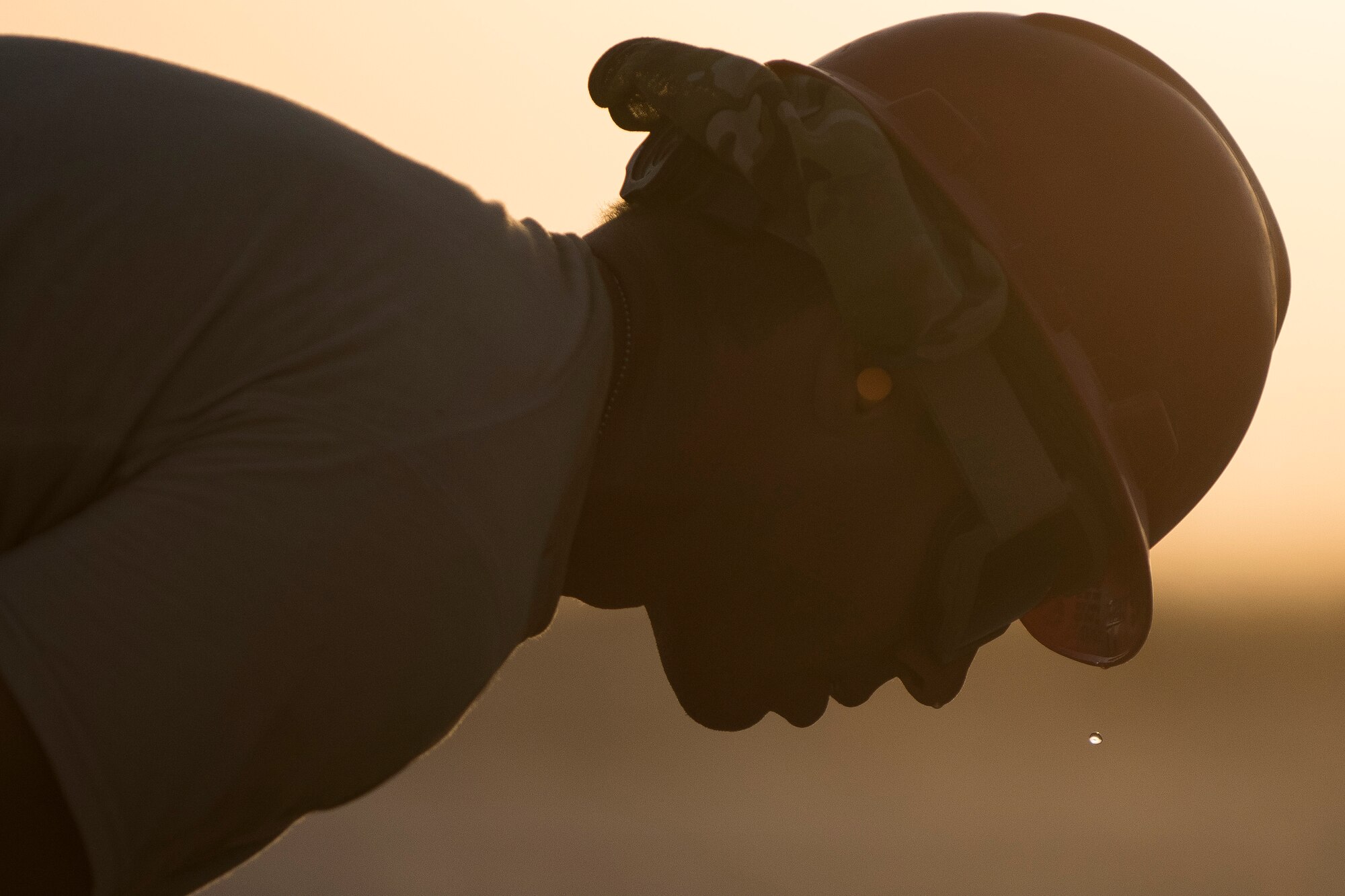 Staff Sgt. Jason Kaza, 557th Expeditionary RED HORSE structural craftsman, works on a construction site June 27, 2017, in Southwest Asia. Working through extreme heat and high winds members of RED HORSE construct pre-engineered buildings vital to the expansion of the 332nd Air Expeditionary Wing and its operational capabilities. (U.S. Air Force photo/Senior Airman Damon Kasberg)