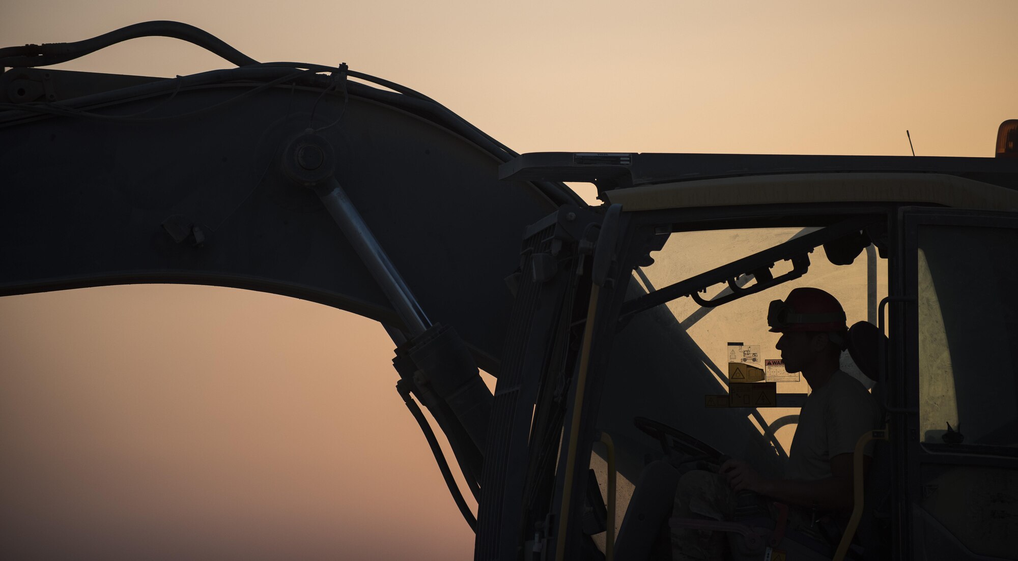 An Airman assigned to the 557th Expeditionary RED HORSE operates an excavator June 2017, in Southwest Asia. RED HORSE provides self-sustaining engineering operations in assessments, planning, programming, design, heavy construction and repair capabilities, offering flexible options to theater commanders to leverage mission sets that would otherwise not be available. (U.S. Air Force photo/Senior Airman Damon Kasberg)