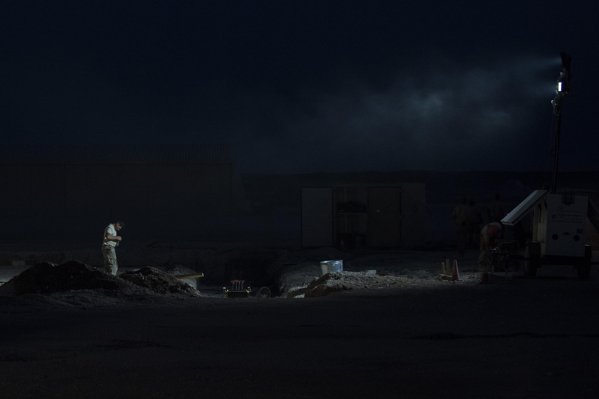 Staff Sgt. Christopher Sword, 557th Expeditionary RED HORSE water fuels maintenance system craftsman, adjusts his eye protection gear June 2017, in Southwest Asia. Working through extreme heat and high winds members of RED HORSE construct pre-engineered buildings vital to the expansion of the 332nd Air Expeditionary Wing and its operational capabilities. (U.S. Air Force photo/Senior Airman Damon Kasberg)