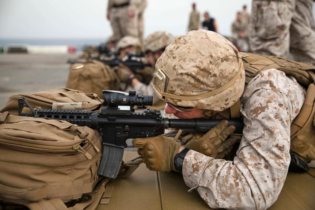 A Marine fires an M4-A4 rifle during a deck shoot aboard the amphibious assault ship USS Bataan in the Gulf of Aden, July 3, 2017. Marine Corps photo by Cpl. Brianna Gaudi