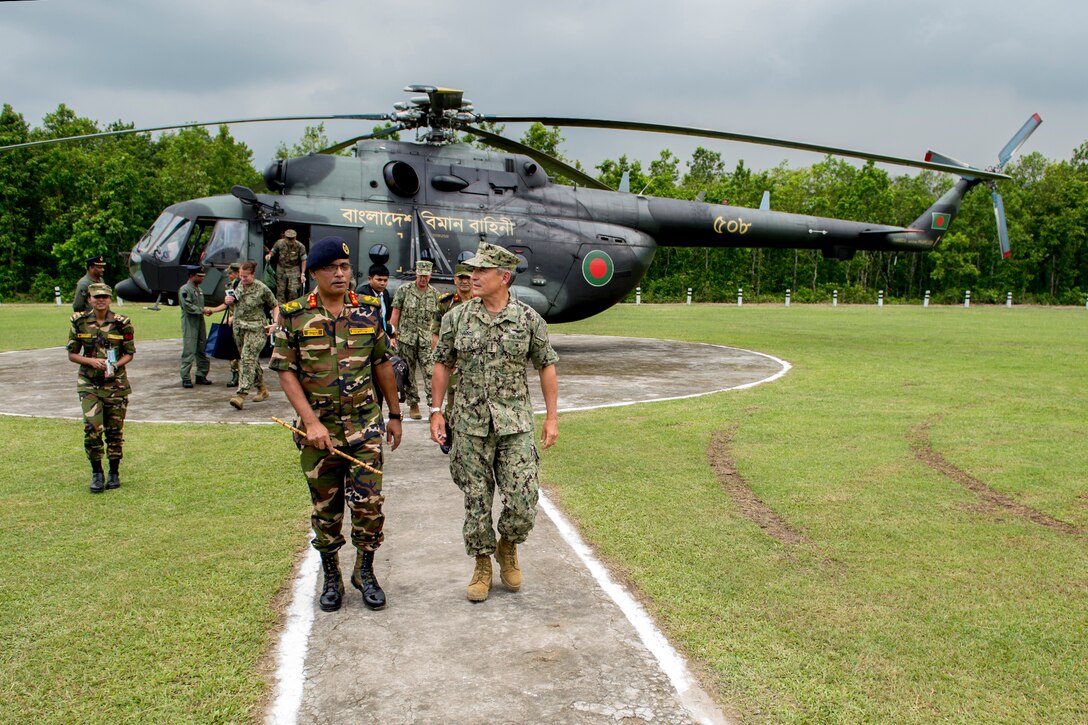 Navy Adm. Harry Harris, commander of U.S. Pacific Command, walks with Maj. Gen. Enayet Ullah, commandant of the Bangladesh Institute of Peace Support Operation Training, after arriving by helicopter in Gazipur, Bangladesh, July 8, 2017. During Harris’ visit to Bangladesh, his first as Pacom commander, he met with counterparts and government officials for discussions on military cooperation and regional security initiatives in the Indo-Asia-Pacific region. Navy photo by Petty Officer 2nd Class Robin W. Peak