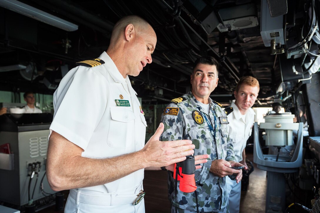 Navy Capt. Nate Moyer, commanding officer of the amphibious transport dock ship USS Green Bay, left, and Cmdr. Peter Mellick, assigned to the Royal Australian Navy, discuss ship maneuvers during a sea and anchor detail in Cairns, Australia, June 28, 2017. The Green Bay, part of the Bonhomme Richard Expeditionary Strike Group, is operating in the Indo-Asia-Pacific region to enhance bilateral partnerships. Navy photo by Petty Officer 3rd Class Sarah Myers